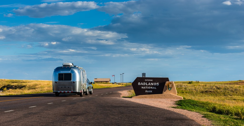 Car and Travel Trailer Entering Badlands National Park South Dakota
