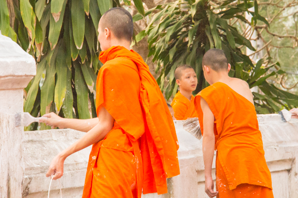 Monks painting a wall at Vat Xienthong temple in Luang Prabang, Laos - 1435