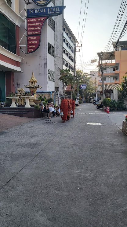buddhist monks at a spirit house.