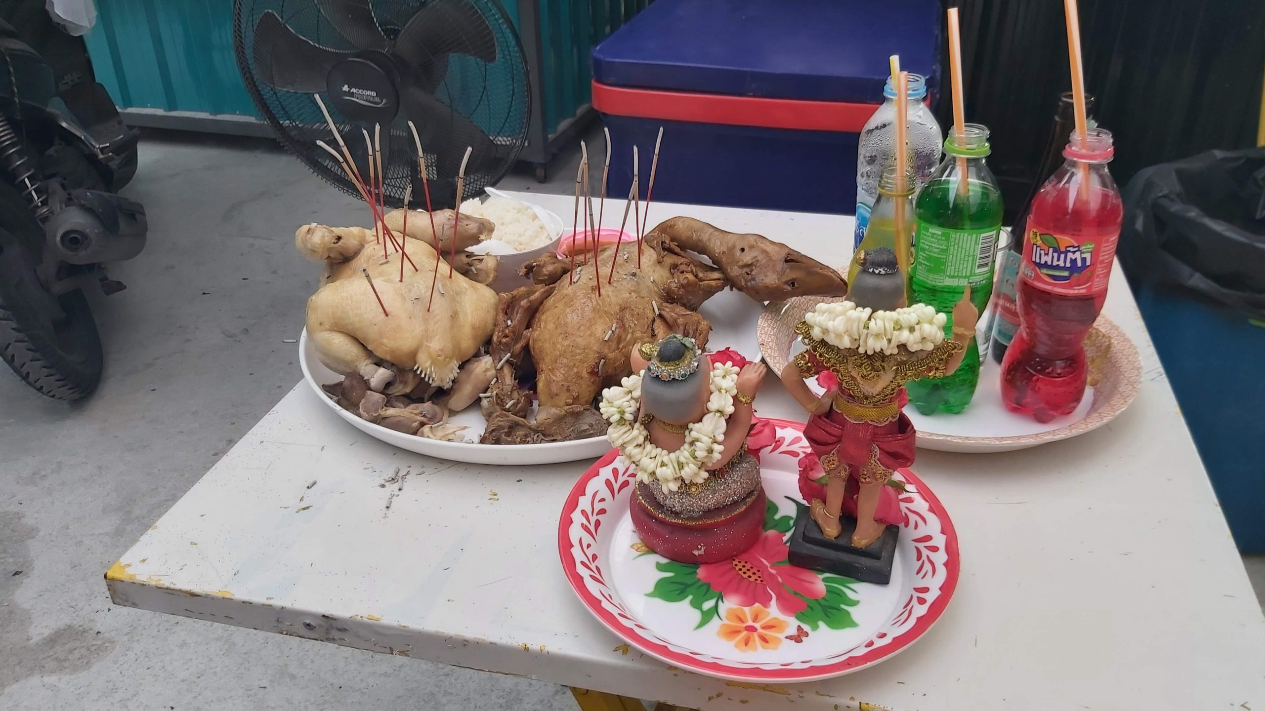 Spirit house offerings, including duck